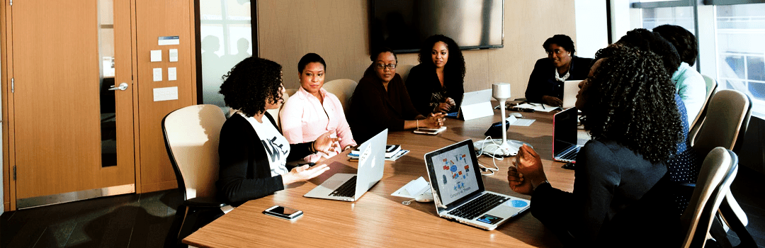 employees sitting in a conference room image